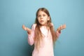 The surprise. Teen girl on a blue background. Facial expressions and people emotions concept Royalty Free Stock Photo