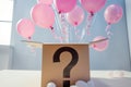 surprise box with question mark opening with pink balloons flying out Royalty Free Stock Photo