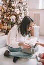 Surprise christmas present - little girl and woman in front of the decorated tree Royalty Free Stock Photo