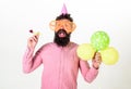 Surprise concept. Hipster in giant sunglasses celebrating birthday. Man with beard and mustache on surprised face holds