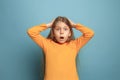 The surprise, happiness, joy, victory, success and luck. Teen girl on a blue background. Facial expressions and people Royalty Free Stock Photo