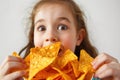 Surprise Girl Eats Nacho Chips On White Background Royalty Free Stock Photo