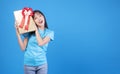 Surprise greeting anniversary birthday or celebration christmas and new year. Cheerful excited young woman holding gold gift box Royalty Free Stock Photo
