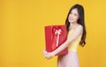 Surprise greeting anniversary birthday or celebration christmas and new year. Cheerful excited young woman holding red gift box Royalty Free Stock Photo