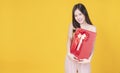 Surprise greeting anniversary birthday or celebration christmas and new year. Cheerful excited young woman holding red gift box Royalty Free Stock Photo