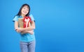 Surprise greeting anniversary birthday or celebration christmas and new year. Cheerful excited young woman holding two red and Royalty Free Stock Photo