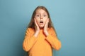 The surprise, happiness, joy, victory, success and luck. Teen girl on a blue background. Facial expressions and people Royalty Free Stock Photo