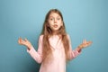 The surprise, happiness, joy, victory, success and luck. Teen girl on a blue background. Facial expressions and people Royalty Free Stock Photo