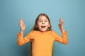 The surprise, happiness, joy, victory, success and luck. Teen girl on a blue background. Facial expressions and people Royalty Free Stock Photo