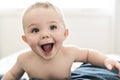 Surprise and happy baby in bed at home Royalty Free Stock Photo