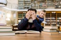 Surprise. Happy world book day, family concept. Small grandson closes with hands eyes of his grandfather, sitting at the Royalty Free Stock Photo