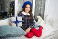 Surprise for her. Kid at home relaxing on cozy window sill. Magic moment. Happy winter holidays. Small girl opening gift Royalty Free Stock Photo