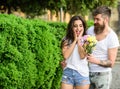 Surprise for her. Man gives flower bouquet girl romantic date. Couple meeting date park background. Guy prepared Royalty Free Stock Photo