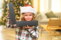 Surprise kid opening Christmas present gift box. Happy funny child in Santa hat holding Christmas gift. Christmas and Royalty Free Stock Photo