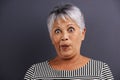 Surprise, portrait and senior woman in studio with crazy, silly or crazy facial expression for comedy. Shock, comic and Royalty Free Stock Photo