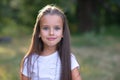 Surprise. Pretty funny little girl with long brown hair posing summer nature outdoor. Cute kid`s portrait. Beautiful child`s fac Royalty Free Stock Photo