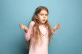 The surprise. Teen girl on a blue background. Facial expressions and people emotions concept