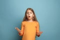 The surprise. Teen girl on a blue background. Facial expressions and people emotions concept Royalty Free Stock Photo