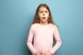 The surprise. Teen girl on a blue background. Facial expressions and people emotions concept Royalty Free Stock Photo