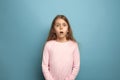 The surprise. Teen girl on a blue background. Facial expressions and people emotions concept Royalty Free Stock Photo