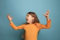 The surprise. Teen girl on a blue background. Facial expressions and people emotions concept Royalty Free Stock Photo