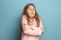 The surprise. Teen girl on a blue background. Facial expressions and people emotions concept Royalty Free Stock Photo