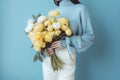 woman blue green white floral hand yellow romantic flower bouquet sweater. Generative AI. Royalty Free Stock Photo