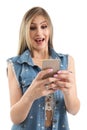 Beautiful woman is looking at the cell phone screen. She`s surpr Royalty Free Stock Photo