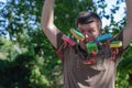 Surprised Adult man holds children`s ships tied to a branch. Fiv