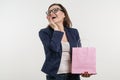 Surprised adult woman looking shopping bag, a white background Royalty Free Stock Photo