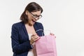Surprised adult woman looking shopping bag, white background Royalty Free Stock Photo
