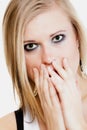 Surprised afraid girl covering mouth with hand