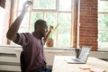 Surprised african-american man excited by online win looking at Royalty Free Stock Photo