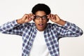 Surprised african-american student touching glasses feeling shocked Royalty Free Stock Photo