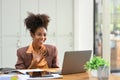 Surprised African American woman looking on laptop screen, getting incredibly pleasant surprise on email