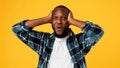 Surprised African Guy Touching Head Looking Posing Over Yellow Background Royalty Free Stock Photo