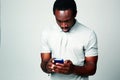 Surprised african man using smartphone Royalty Free Stock Photo