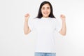 Surprised asian woman in blank white t shirt isolated. Excited and happy young korean girl. Copy space