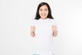Surprised asian woman in blank white t shirt isolated. Excited and happy young korean girl. Copy space.