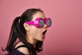 Surprised asian woman, Shocking girl wearing funny glasses on isolated pink background. Royalty Free Stock Photo