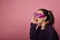 Surprised asian woman, Shouting girl wearing funny glasses on isolated pink background, Wow face feelings. Royalty Free Stock Photo