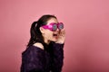 Surprised asian woman, Shouting girl wearing funny glasses on  pink background. Royalty Free Stock Photo