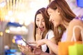 Surprised woman watching phone in the shopping mall Royalty Free Stock Photo