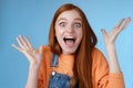 Surprised astonished sensitive overwhelmed young happy redhead girl receive incredible fantastic prize wide eyes Royalty Free Stock Photo