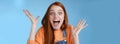 Surprised astonished sensitive overwhelmed young happy redhead girl receive incredible fantastic prize wide eyes Royalty Free Stock Photo