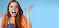 Surprised astonished sensitive overwhelmed young happy redhead girl receive incredible fantastic prize wide eyes Royalty Free Stock Photo