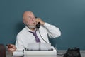 Surprised author journalist at work. Table with telephone and typewriter. Vintage. Writer editor Royalty Free Stock Photo