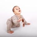 Surprised baby boy in cream clothes playing with sunglasses Royalty Free Stock Photo