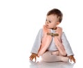 Surprised baby girl in warm clothes sit on floor Royalty Free Stock Photo