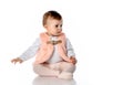 Surprised baby girl in warm clothes sit on floor Royalty Free Stock Photo